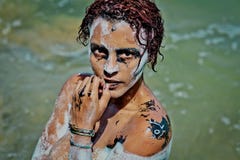 The girl washed after painting on the body and face in halloween style stock images The girl washed after painting on the body and face in halloween style stock images