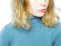 A girl wearing grey sweater. A young beautiful girl wearing grey sweater on a white background. Close-up Royalty Free Stock Photography A girl wearing grey sweater. A young beautiful girl wearing grey sweater on a white background. Close-up Royalty Free Stock Photography