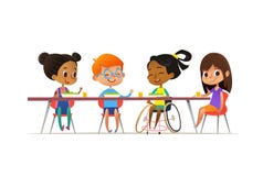 Girl in wheelchair sitting at table in canteen and talking to her friends. Happy multiracial kids having lunch. School inclusion c
