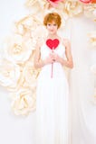 Girl in white dress with red heart in hands stock photos Girl in white dress with red heart in hands stock photos