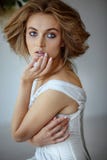 Girl in white retro linen that creates in the studio stock photo Girl in white retro linen that creates in the studio stock photo