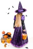 Girl in a Witch Dress with Halloween Accessories and full Bucket