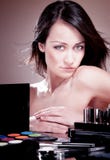 Girl With Cosmetics For Makeup. Royalty Free Stock Photo
