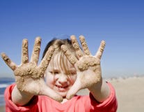 Girl With Hands Covered With Sand Stock Photography