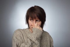 Girl wrinkles her nose from the stench or odor royalty free stock images Girl wrinkles her nose from the stench or odor royalty free stock images
