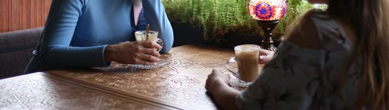 Girlfriends enjoying in cafe together. Young women meeting in a cafe. meeting two women in a cafe for coffee. blue dress, dress in stock images Girlfriends enjoying in cafe together. Young women meeting in a cafe. meeting two women in a cafe for coffee. blue dress, dress in stock images