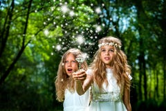 Girls casting magic spells in woods.