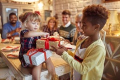Beautiful girls celebration holiday and giving Christmas present stock photo Beautiful girls celebration holiday and giving Christmas present stock photo