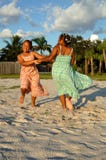 Girls dancing on sand at beach