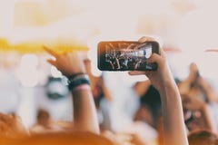 Girls use smartphones to take pictures at concerts stock image Girls use smartphones to take pictures at concerts stock image