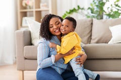 Gl?ckliche Afroamerikanermutter mit Baby zu Hause stockfotos Gl?ckliche Afroamerikanermutter mit Baby zu Hause stockfotos