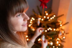 Gl?ckliche junge Frau, die zu Hause Weihnachtsbaum verziert Winterurlaube in einem Hausinnenraum Goldenes und wei?es Weihnachten stockbilder Gl?ckliche junge Frau, die zu Hause Weihnachtsbaum verziert Winterurlaube in einem Hausinnenraum Goldenes und wei?es Weihnachten stockbilder