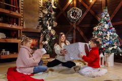 Glad jul och lyckligt nytt år Gladlynt mamma och hennes gulliga dotter och son som utbyter gåvor Förälder och barn arkivbilder Glad jul och lyckligt nytt år Gladlynt mamma och hennes gulliga dotter och son som utbyter gåvor Förälder och barn arkivbilder