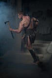Gladiator in armour standing on steps of ancient stock photography Gladiator in armour standing on steps of ancient stock photography