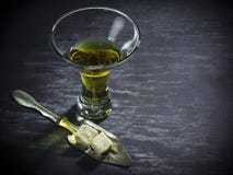 Glass of Absinthe with sugar cubes and spoon Stock Photos Glass of Absinthe with sugar cubes and spoon Stock Photos