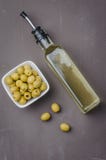 Glass Bottle Of Olive Oil And Olive In A White Bowl On A Dark Background. Top View. Organic Olive Oil Concept Royalty Free Stock Photo