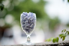 A glass of clear wine with white paper inside the concept of filling the good things into a glass of clear one. stock photo A glass of clear wine with white paper inside the concept of filling the good things into a glass of clear one. stock photo