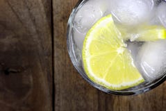 glass of cold water with ice and lemon on a wooden table. close up. royalty free stock images glass of cold water with ice and lemon on a wooden table. close up. royalty free stock images