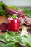 Glass of fresh beetroot juice with bets on wooden table. stock image Glass of fresh beetroot juice with bets on wooden table. stock image