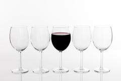 Glass Of Red Wine In A Row Of Empty Glasses Royalty Free Stock Images