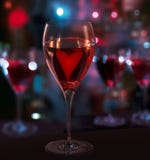 Glass Of Red Wine, With Heart. Blurred City Lights Stock Images