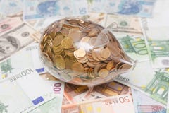 Glass piggy bank over Euro and Dollars royalty free stock image Glass piggy bank over Euro and Dollars royalty free stock image