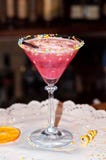 Glass with red alcohol drink and straw on white paper napkin with dried orange slice royalty free stock photography Glass with red alcohol drink and straw on white paper napkin with dried orange slice royalty free stock photography