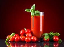Glass of tomato juice with red small tomatoes royalty free stock photos Glass of tomato juice with red small tomatoes royalty free stock photos