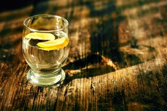 A glass of water and a lemon royalty free stock images A glass of water and a lemon royalty free stock images