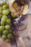 Glass of white wine and grapes stock image Glass of white wine and grapes stock image