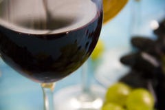 Glass of wine merlot, grapes appetizer vintage creative celebration menu natural vintage card on a blue wooden background stock images Glass of wine merlot, grapes appetizer vintage creative celebration menu natural vintage card on a blue wooden background stock images