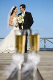Glasses with bride and groom