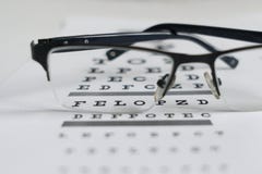 Glasses in the hands on the background of the table for vision royalty free stock images Glasses in the hands on the background of the table for vision royalty free stock images