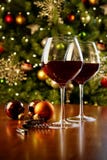 Glasses Of Red Wine On Table With Christmas Tree Stock Photos Glasses Of Red Wine On Table With Christmas Tree Stock Photos