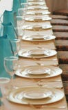Glasses and plates in a row