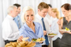 Glimlachende bedrijfsvrouw tijdens het buffet van de bedrijflunch