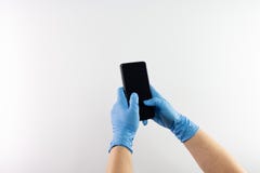 Gloved hands holding a mobile phone