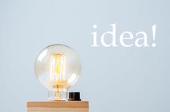Glowing yellow light bulb on blue background. Got idea. Copy space royalty free stock photo Glowing yellow light bulb on blue background. Got idea. Copy space royalty free stock photo