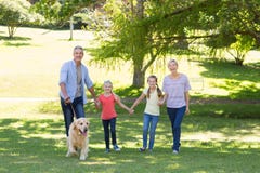 Glückliche Familie, die in den Park mit ihrem Hund geht stockfotos Glückliche Familie, die in den Park mit ihrem Hund geht stockfotos
