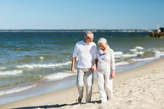 Glückliches älteres Paarhändchenhalten auf Sommerstrand stockbilder Glückliches älteres Paarhändchenhalten auf Sommerstrand stockbilder