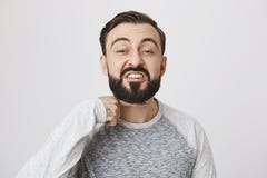 Gniewny brodaty faceta seans cię ciebie przewodzić daleko gest z palcem wskazującym nad szyją, stoi nad szarym tłem Ja zdjęcie royalty free Gniewny brodaty faceta seans cię ciebie przewodzić daleko gest z palcem wskazującym nad szyją, stoi nad szarym tłem Ja zdjęcie royalty free