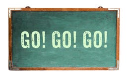 `Go! Go! Go!†motivational text word message written on a wide green old grungy vintage wooden chalkboard royalty free stock photography `Go! Go! Go!†motivational text word message written on a wide green old grungy vintage wooden chalkboard royalty free stock photography