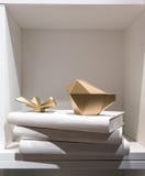 Gold abstract paperweight placing on a stack of white cover book royalty free stock photo Gold abstract paperweight placing on a stack of white cover book royalty free stock photo