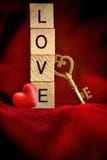 Gold key with wooden letters that spell the word love stock photography Gold key with wooden letters that spell the word love stock photography