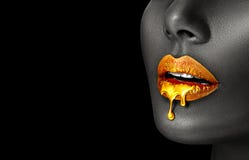 Gold Paint smudges drips from African American woman face, lips lipgloss dripping from sexy lips, golden liquid drops