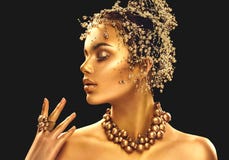 Gold woman skin. Beauty fashion model girl with golden makeup