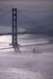 Golden Gate Bridge in fog 2 (with sailboat) Stock Photography Golden Gate Bridge in fog 2 (with sailboat) Stock Photography