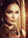 Golden holiday makeup. Fashion art hairstyle, manicure and makeup royalty free stock photography Golden holiday makeup. Fashion art hairstyle, manicure and makeup royalty free stock photography
