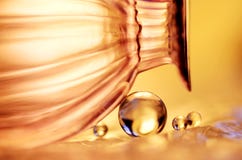 Golden Marbles And A Glass Royalty Free Stock Photo