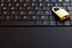Golden padlock on black keyboard royalty free stock photo Golden padlock on black keyboard royalty free stock photo